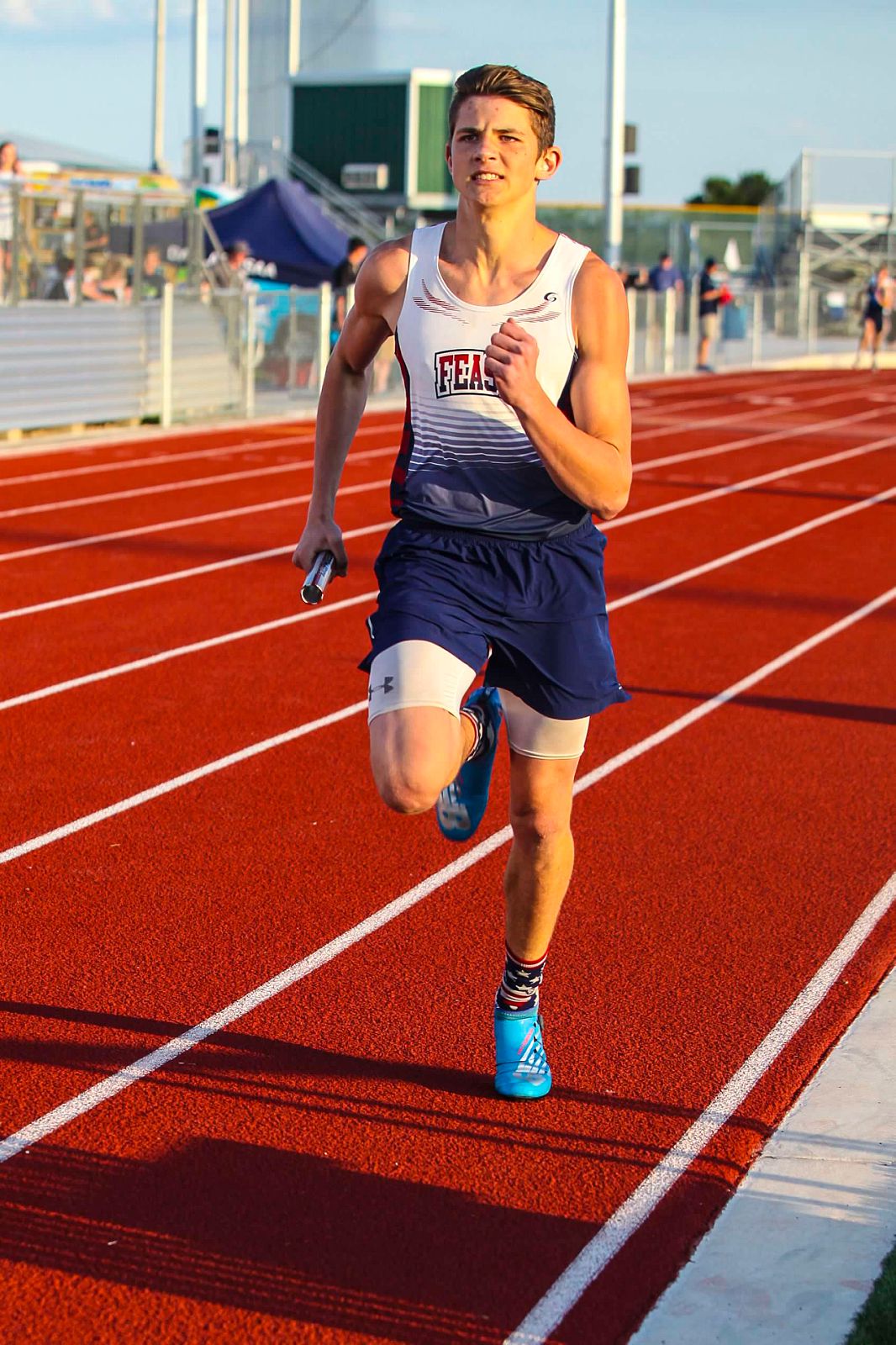 Isaiah Hudgens running a relay for the FEAST Patriots in high school