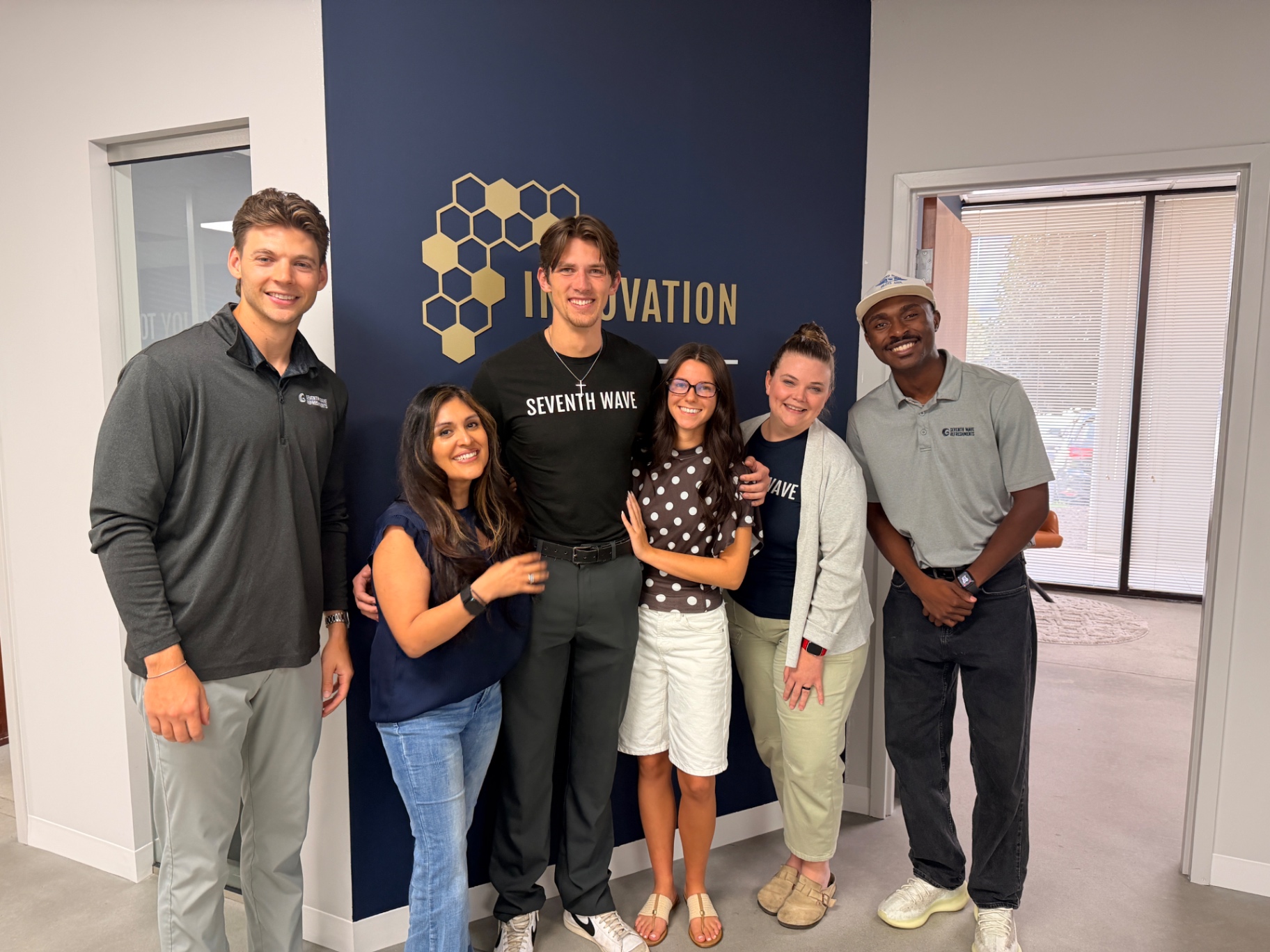 Isaiah Hudgens with his Seventh Wave Innovation coworkers before leaving his job to train full-time